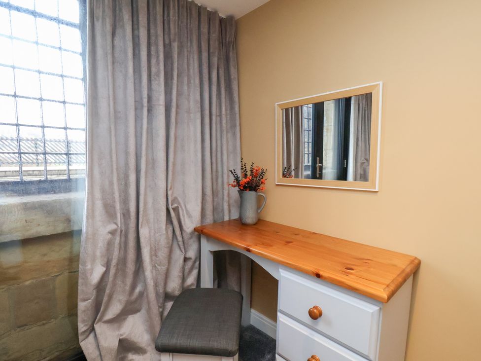 A bedroom with a desk and mirror at Olton Hall @ Engine Shed in Whitby