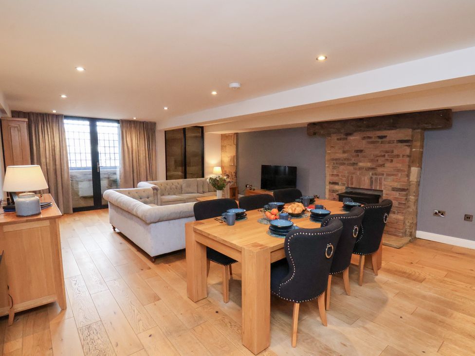 A living room with a dining area and fireplace at Mallard @ Engine Shed in Whitby