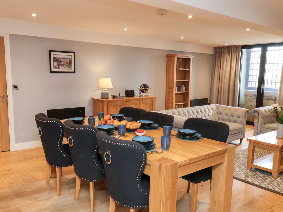 A dining room with a table set for dinner at Mallard @ Engine Shed in Whitby