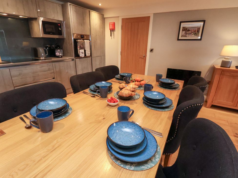 A dining room with table set for meals at Mallard @ Engine Shed in Whitby