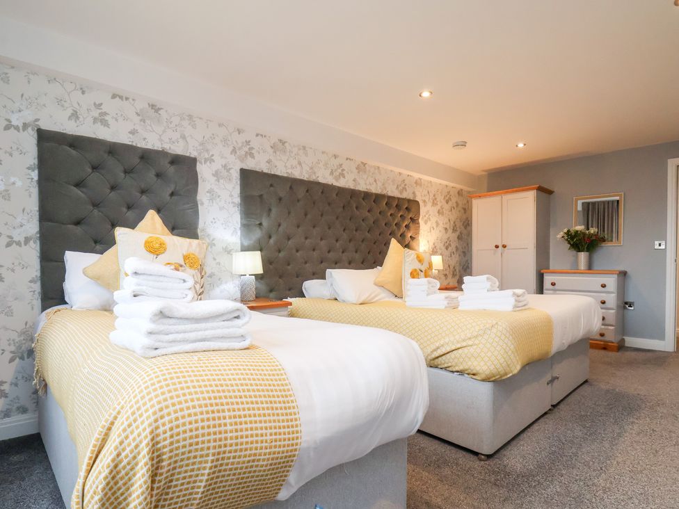 A bedroom with two beds and a dresser at Mallard @ Engine Shed in Whitby