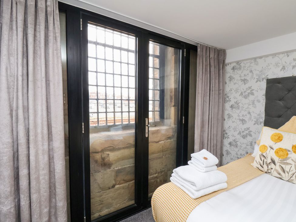 A bedroom with a bed and window at Mallard @ Engine Shed Whitby