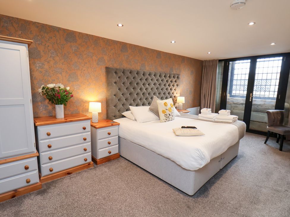 A bedroom with a bed, nightstands, and dresser at Mallard @ Engine Shed in Whitby