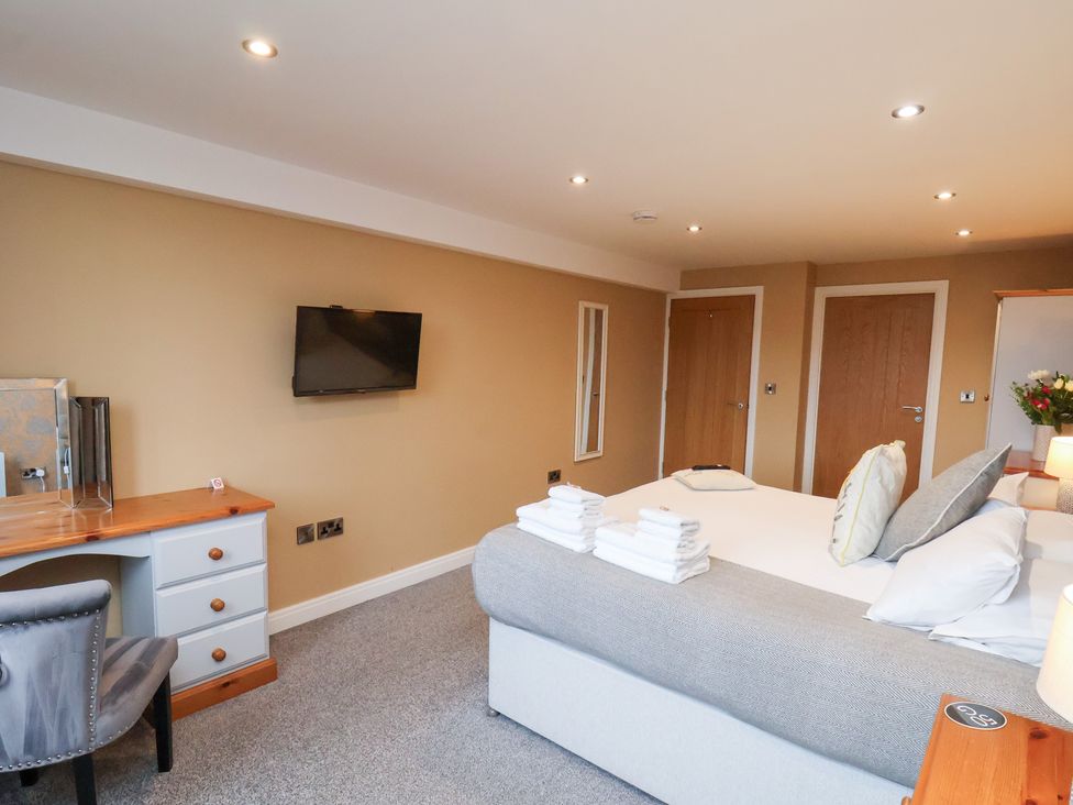 A bedroom with a bed and desk at Mallard @ Engine Shed Whitby