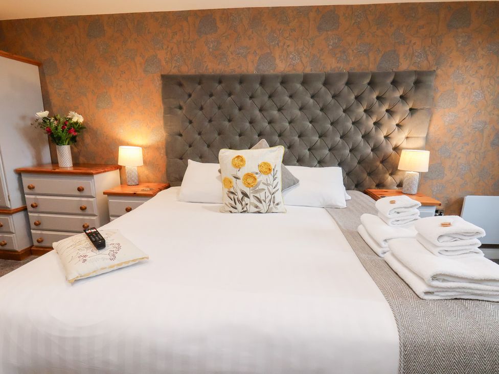 A bedroom with a bed, pillows, and a lamp at Mallard @ Engine Shed in Whitby