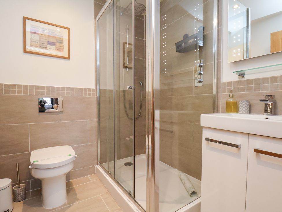 A bathroom featuring a shower, toilet, and sink at Mallard @ Engine Shed in Whitby