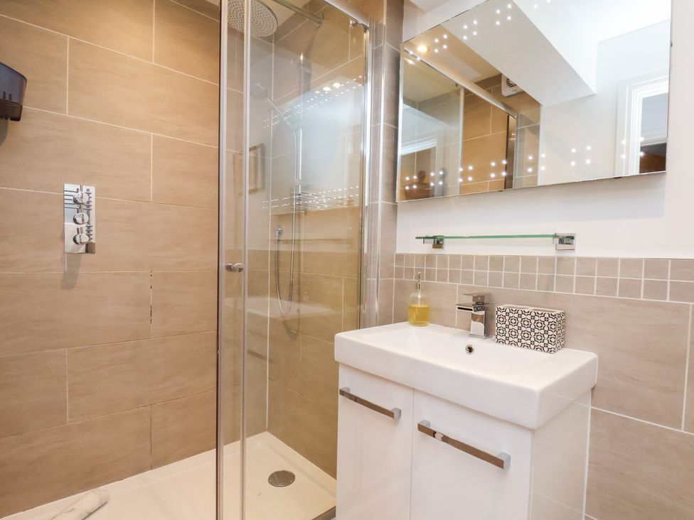 A bathroom with a shower and sink at Mallard @ Engine Shed in Whitby