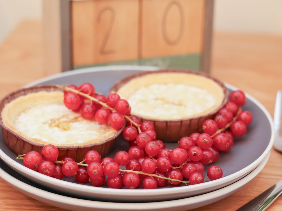 Two tarts and redcurrants on plates at Evening Star @ Engine Shed Whitby