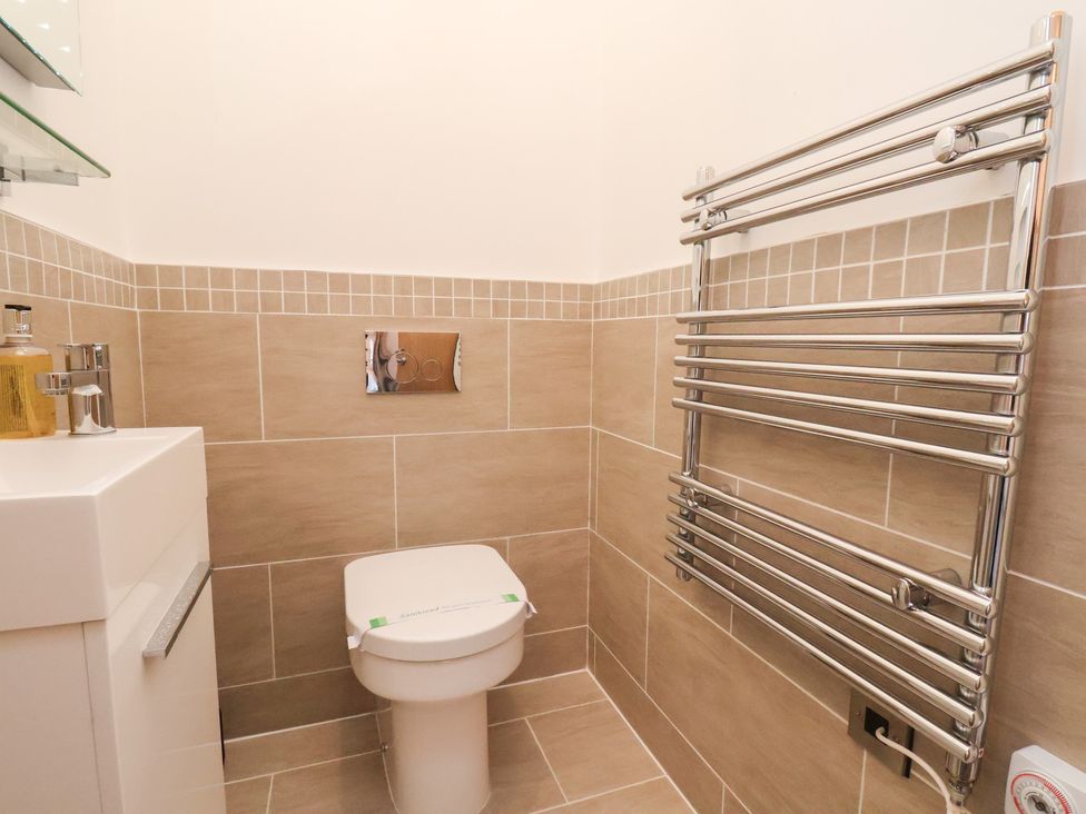 A bathroom with a toilet and sink at Evening Star @ Engine Shed Whitby