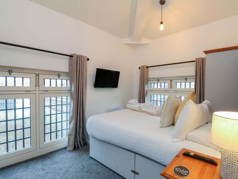 A bedroom with a bed and television at Evening Star @ Engine Shed Whitby