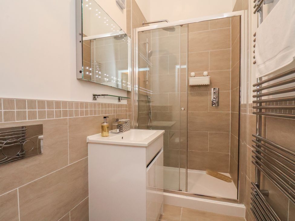 A bathroom with a shower and sink at Evening Star @ Engine Shed in Whitby