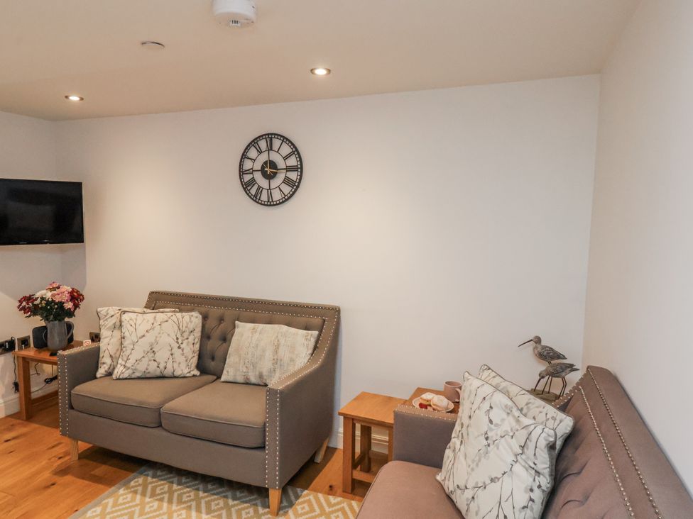 A living room with a sofa and television at George Stephenson @ Engine Shed, Whitby