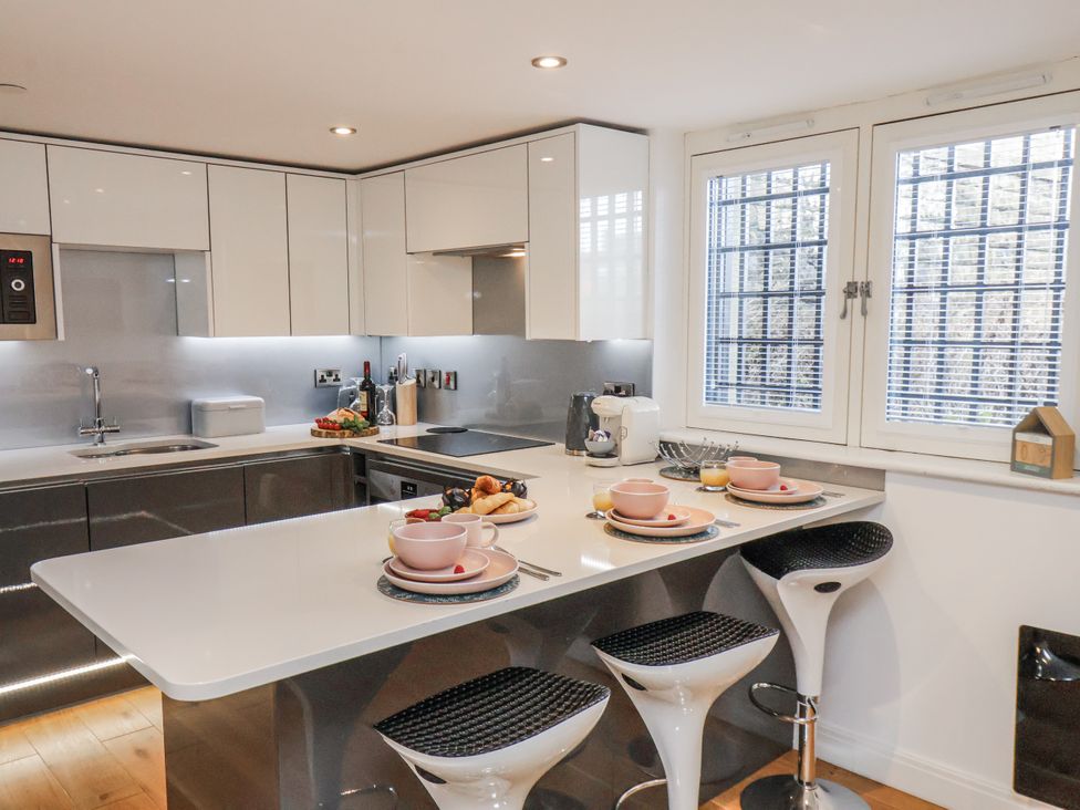 A kitchen with a countertop and bar stools at George Stephenson @ Engine Shed Whitby