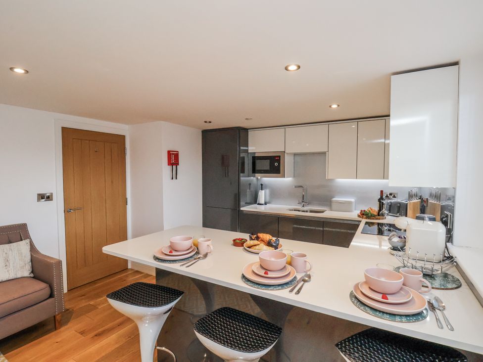 A kitchen with table and stools at George Stephenson @ Engine Shed in Whitby