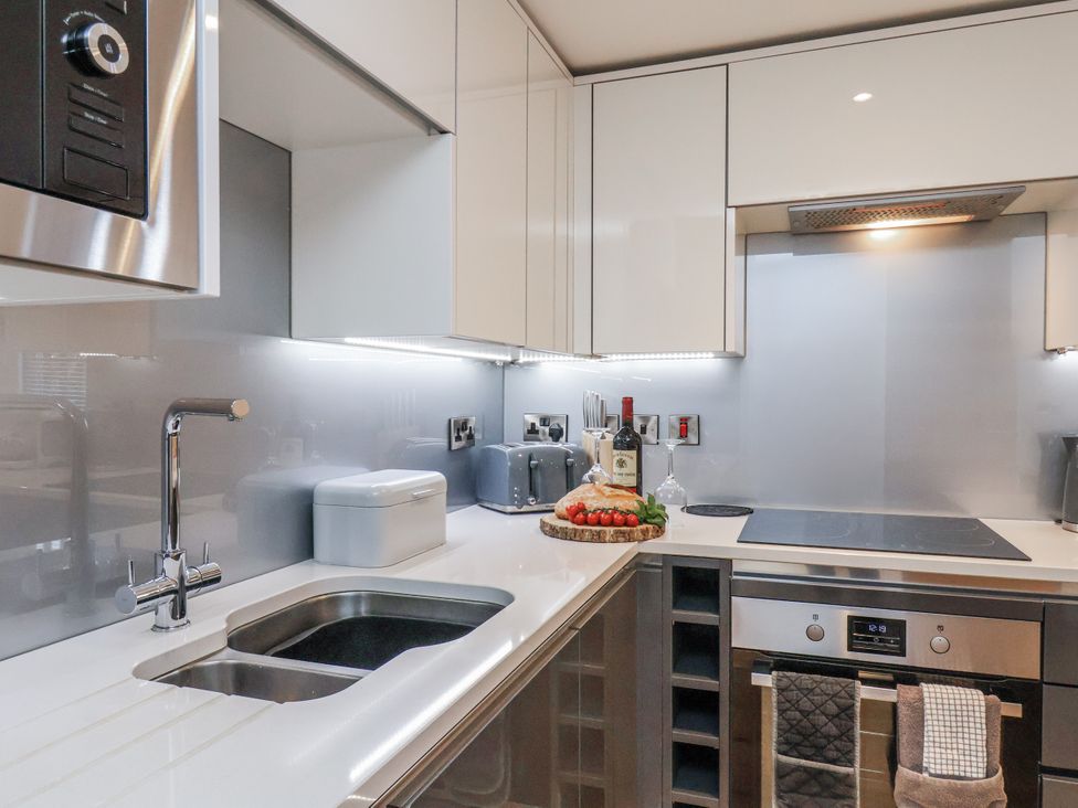 A kitchen with stove and wine bottle at George Stephenson @ Engine Shed Whitby