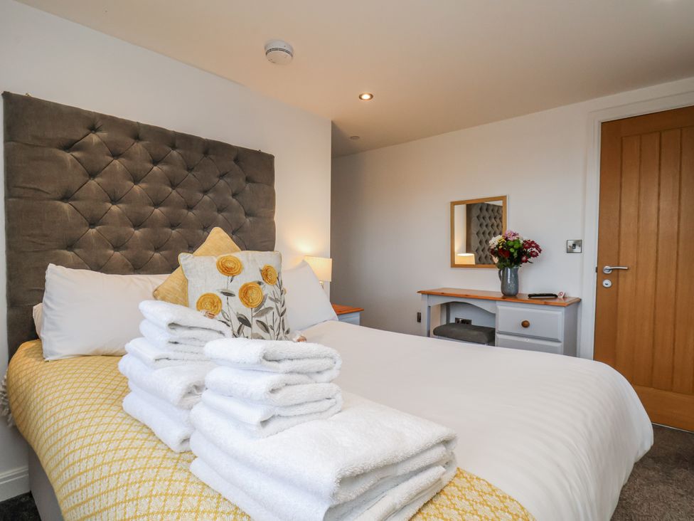 A bedroom with a bed and table at George Stephenson @ Engine Shed in Whitby