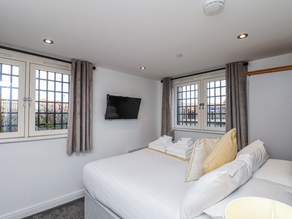 A bedroom with a bed and television at George Stephenson @ Engine Shed Whitby