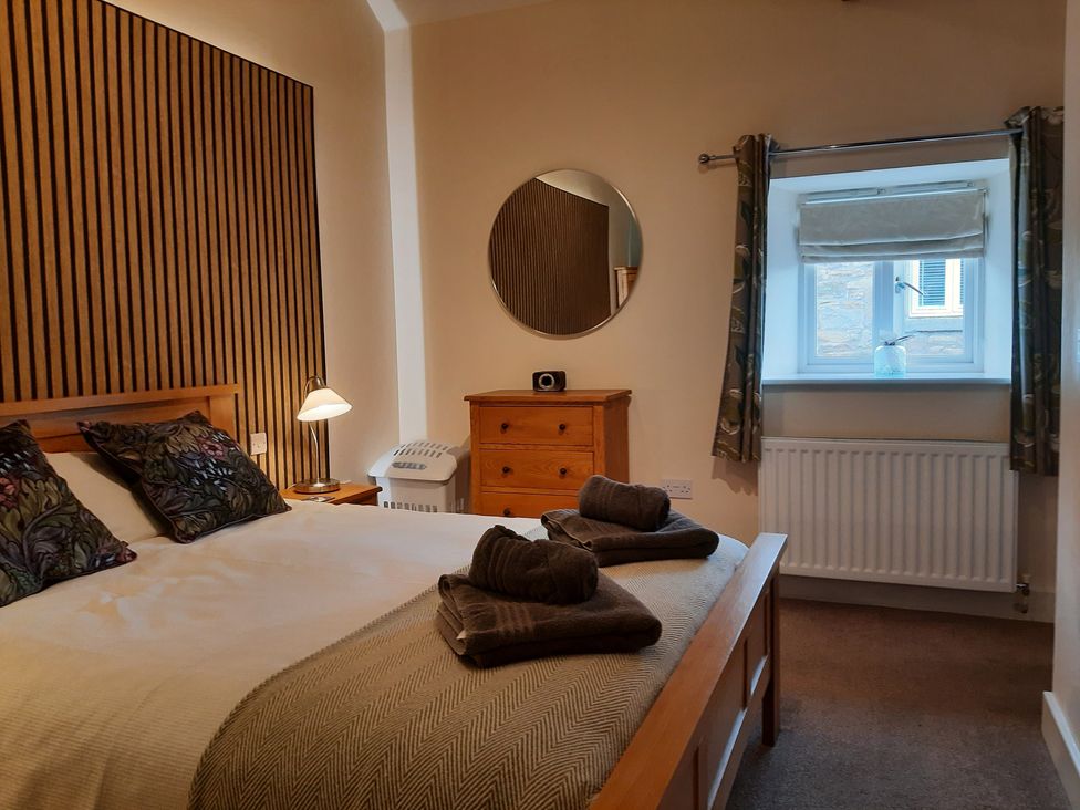 A bedroom with a bed and chest of drawers at Hemmel Cottage in Chatton