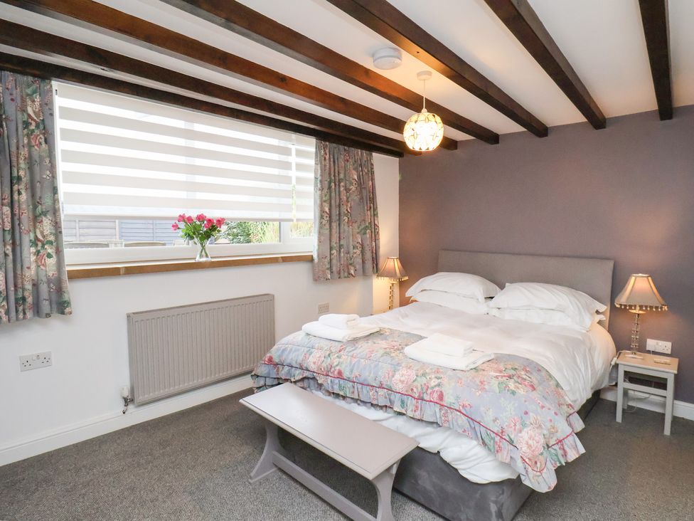 A bedroom with a double bed and window at Mill House in Robin Hood's Bay