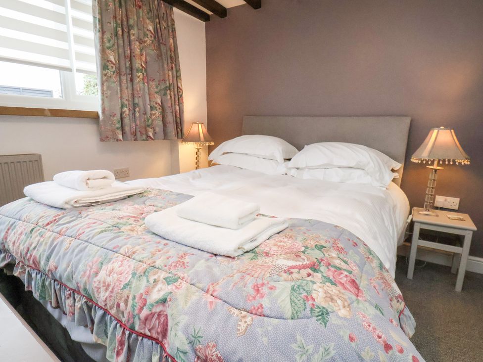 A bedroom with a bed and bedside lamps at Mill House in Robin Hood's Bay