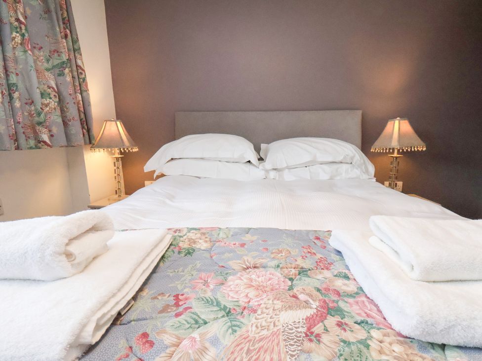 A bedroom with a bed and bedside lamps at Mill House in Robin Hood's Bay