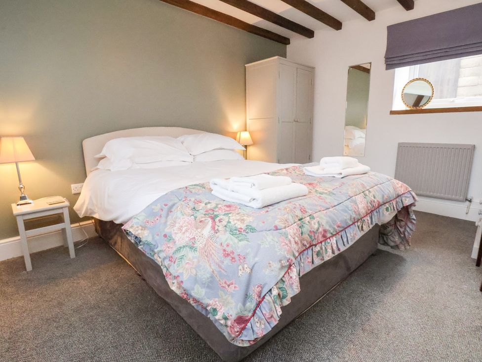 A bedroom with a double bed and bedside table at Mill House in Robin Hood's Bay