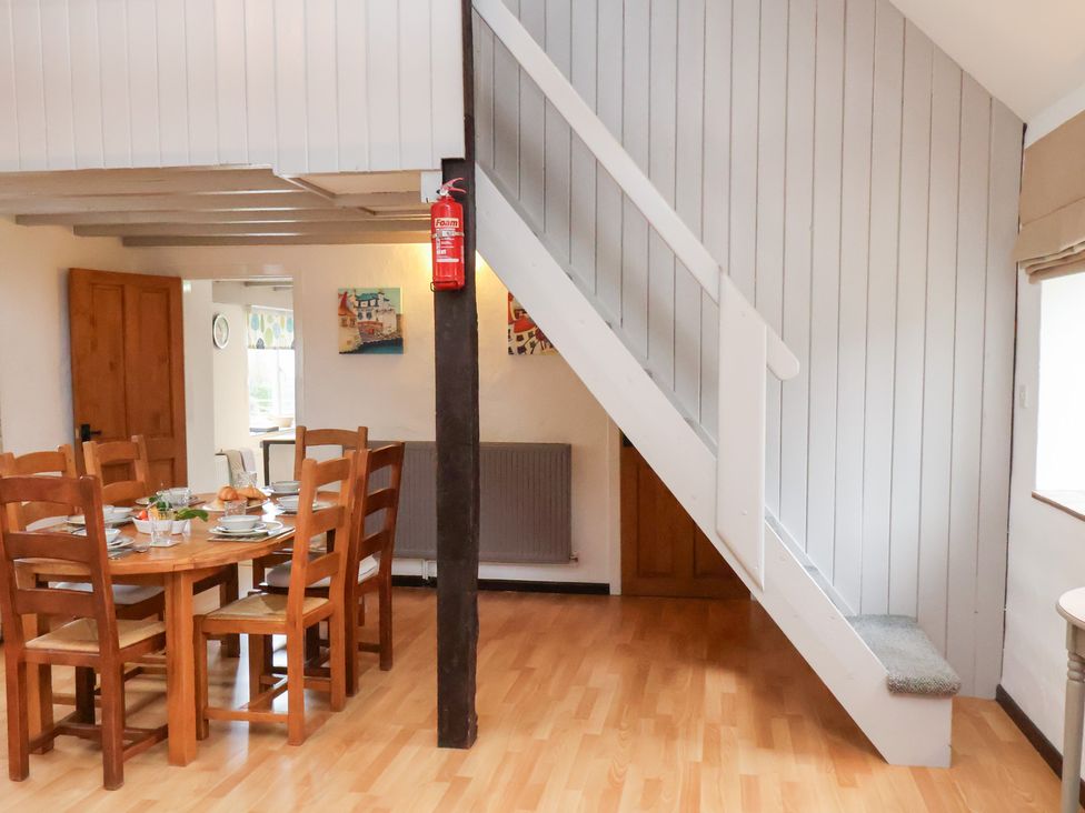 A dining room with a table and chairs at Stable Cottage in Robin Hoods Bay