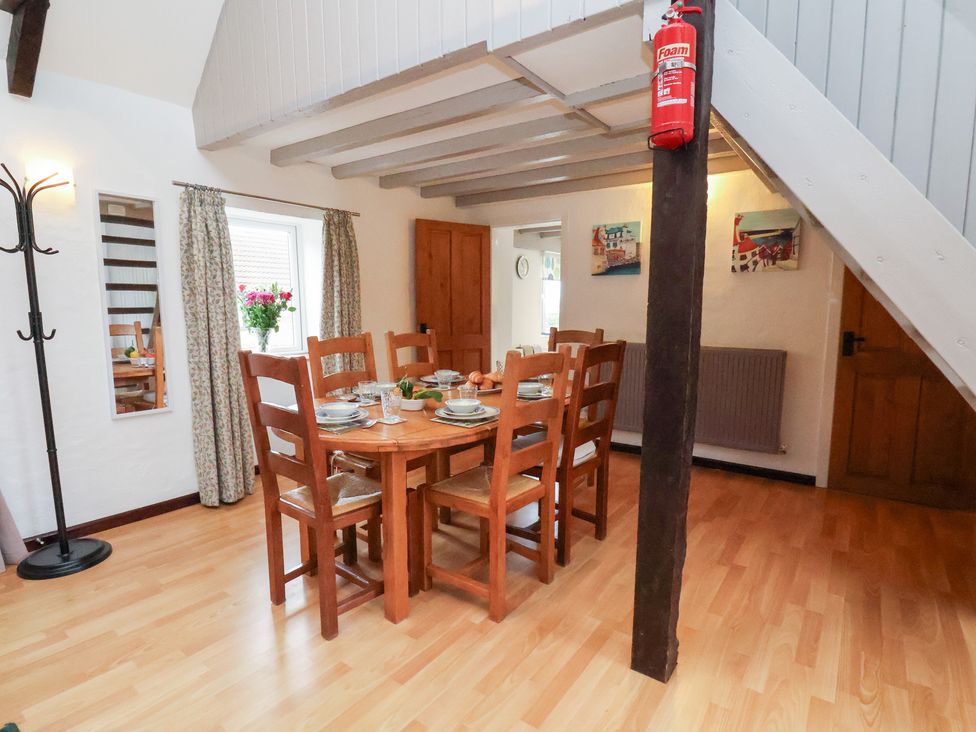 A dining room with a table and chairs at Stable Cottage in Robin Hoods Bay