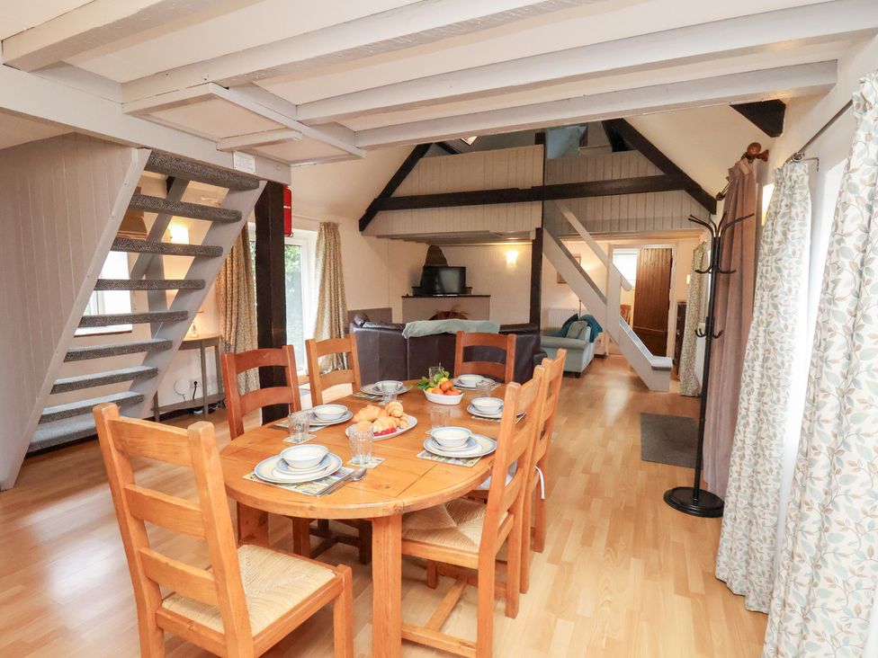 A dining room with a table and chairs at Stable Cottage in Robin Hoods Bay