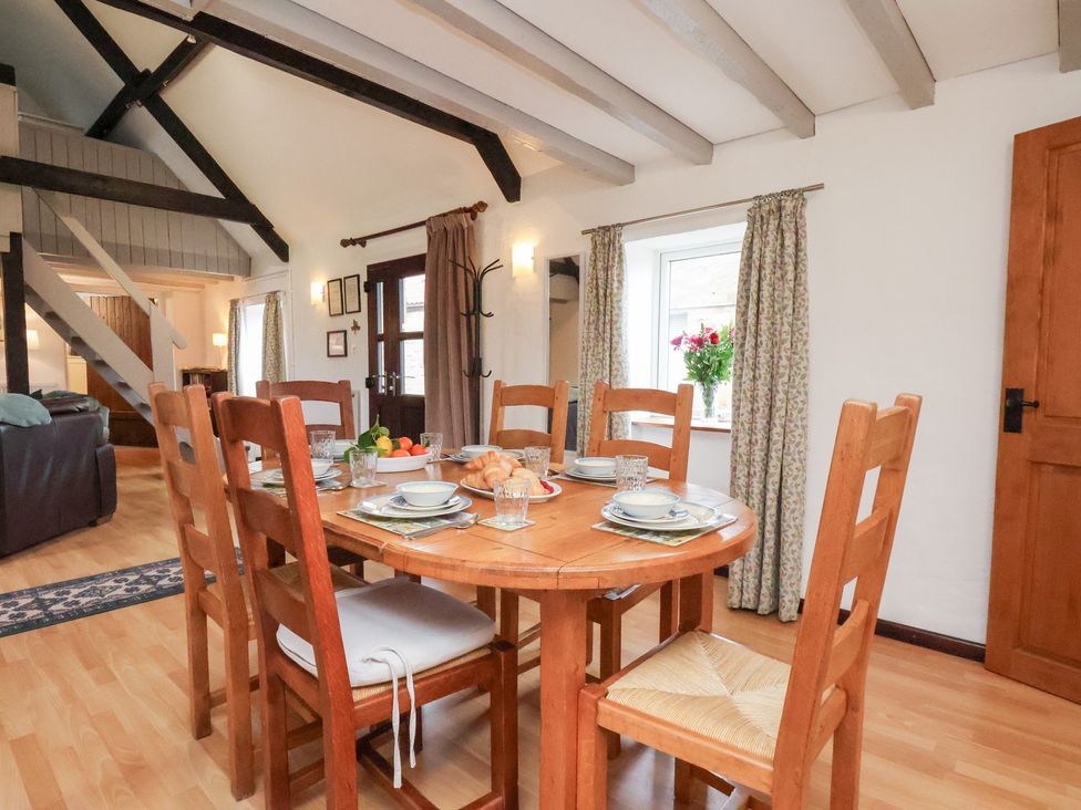 A dining room with a table and chairs at Stable Cottage in Robin Hoods Bay
