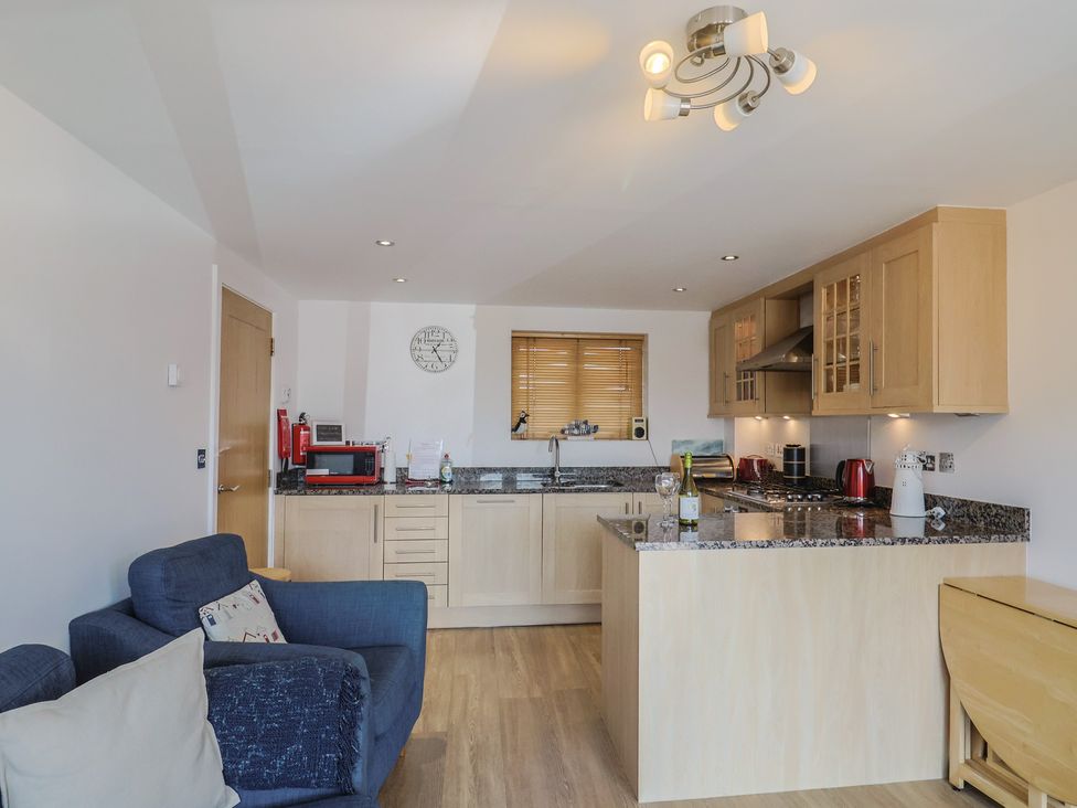 A kitchen with a sink, stove, and microwave at Harbourwalk in West Bay