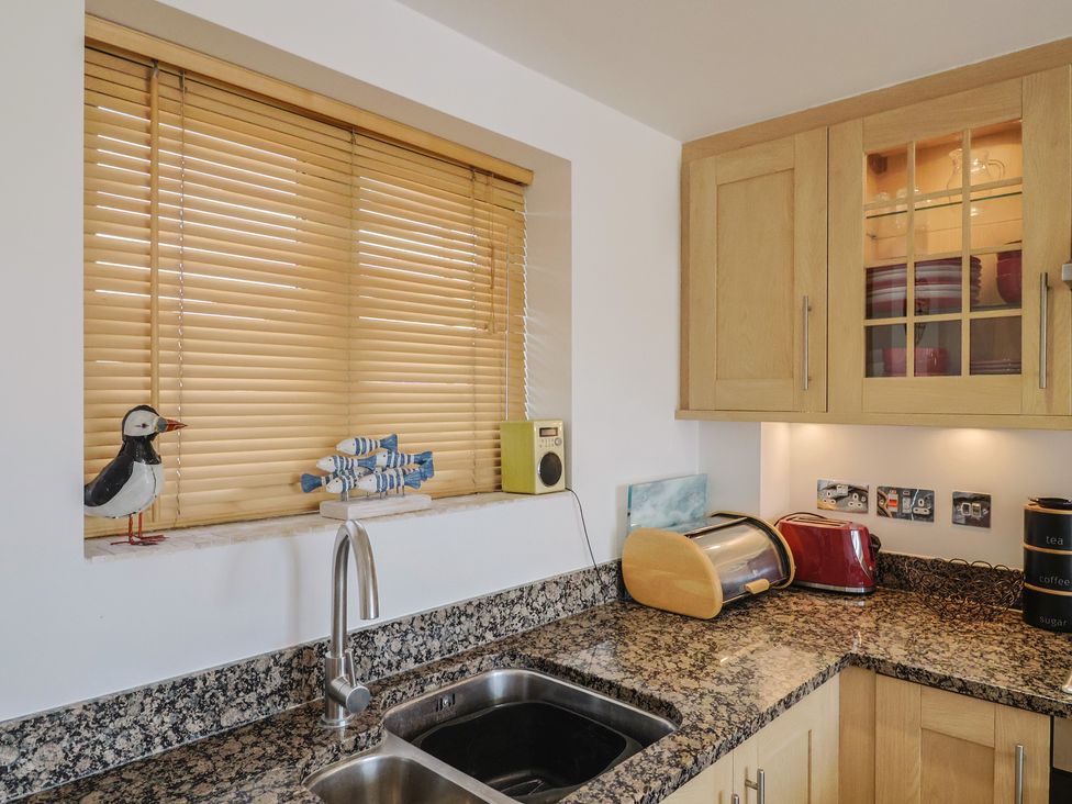 A kitchen with a sink and toaster at Harbourwalk in West Bay