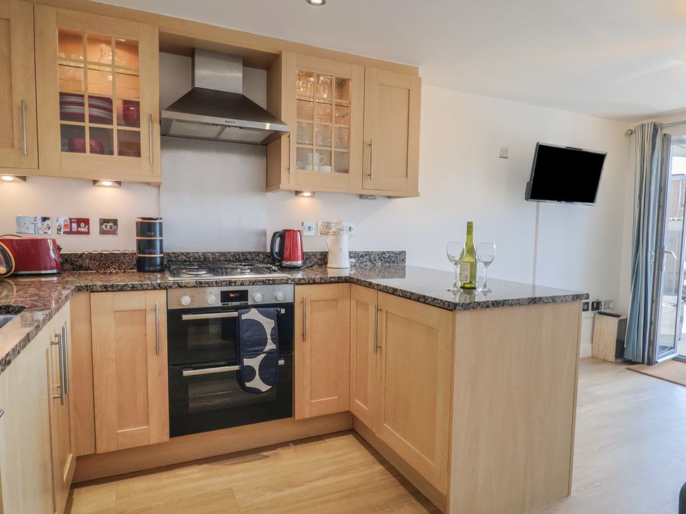 A kitchen with cabinets and appliances at Harbourwalk West Bay