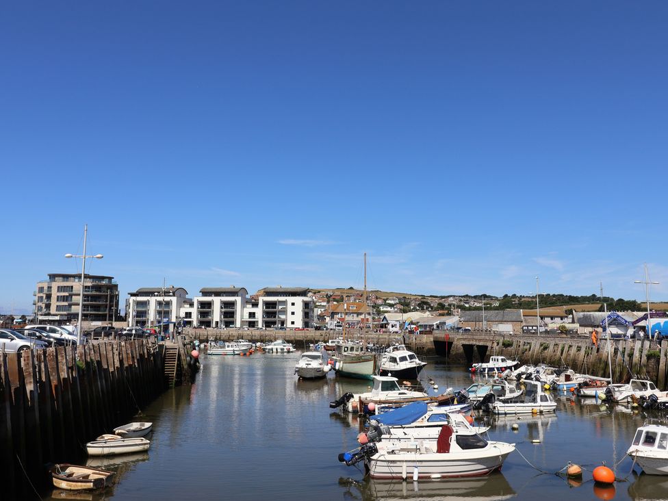 A harbor with boats and buildings at Harbourwalk in West Bay