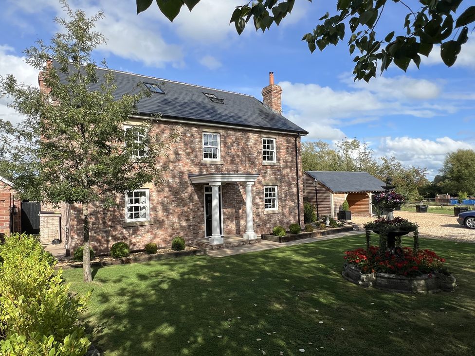 A house with a garden and pathway at Moor End Manor Stalmine