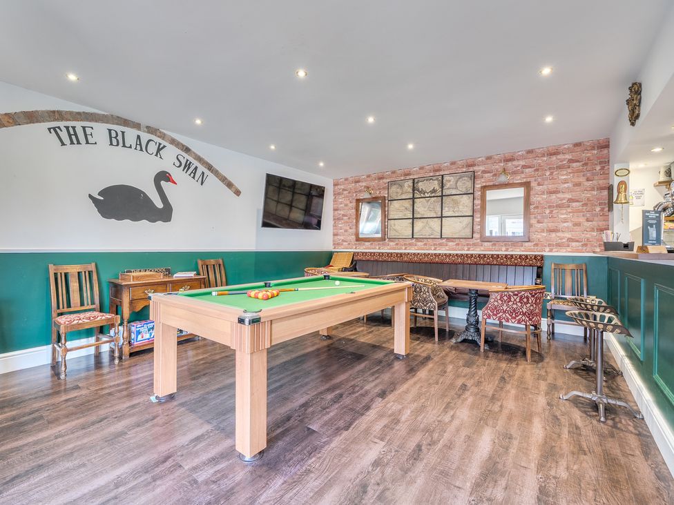 A game room with a pool table and seating at Moor End Manor Stalmine
