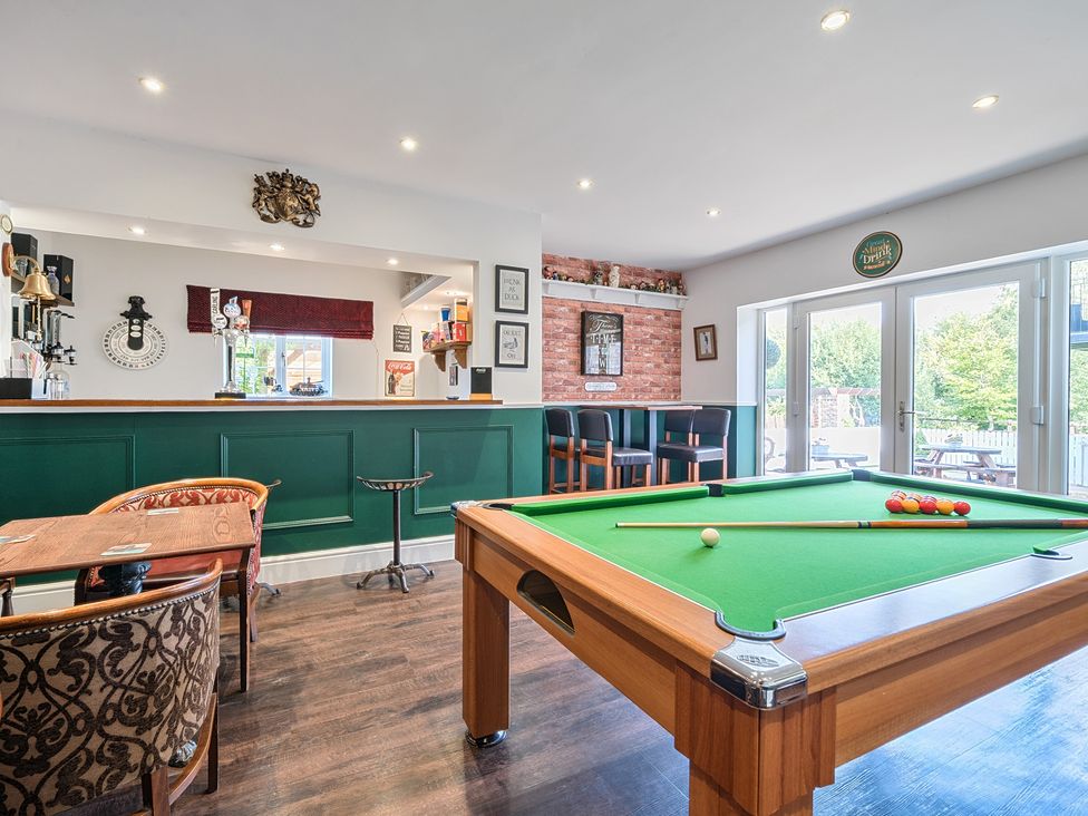A snug with a pool table and bar area at Moor End Manor in Stalmine