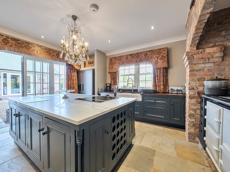 A kitchen with an island and sink at Moor End Manor in Stalmine