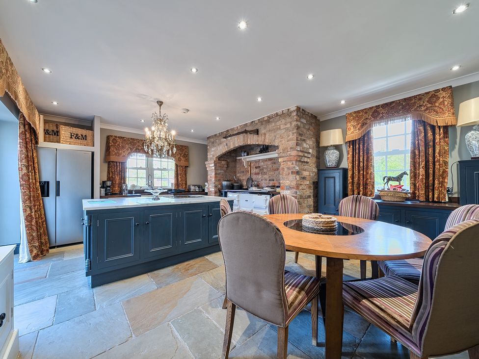 A kitchen with a dining table and chairs at Moor End Manor Stalmine