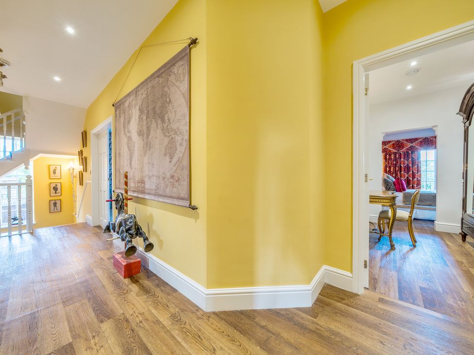 A hallway with a map on the wall and a toy horse at Moor End Manor Stalmine