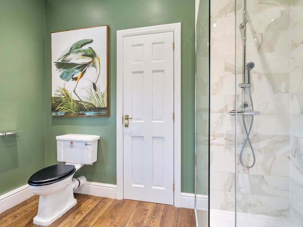 A bathroom featuring a toilet and a shower at Moor End Manor in Stalmine