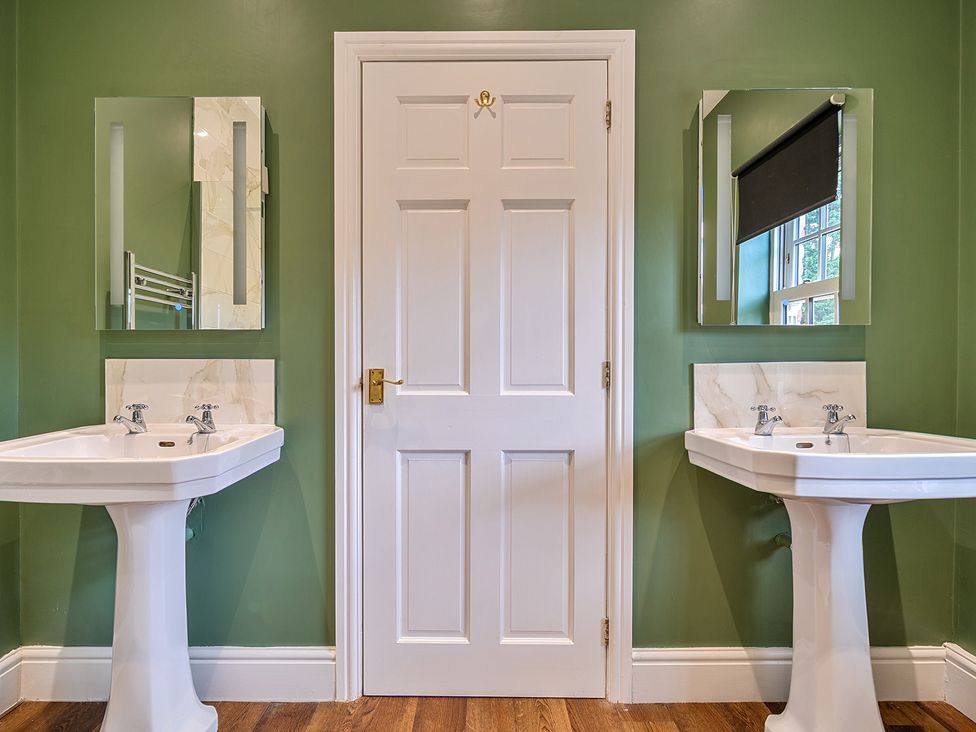 A bathroom with sinks and mirrors at Moor End Manor in Stalmine