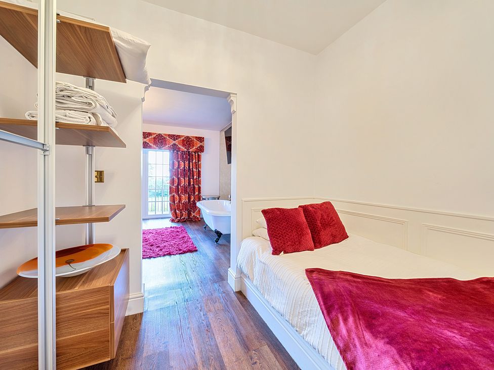 A bedroom with a bed and shelf at Moor End Manor in Stalmine