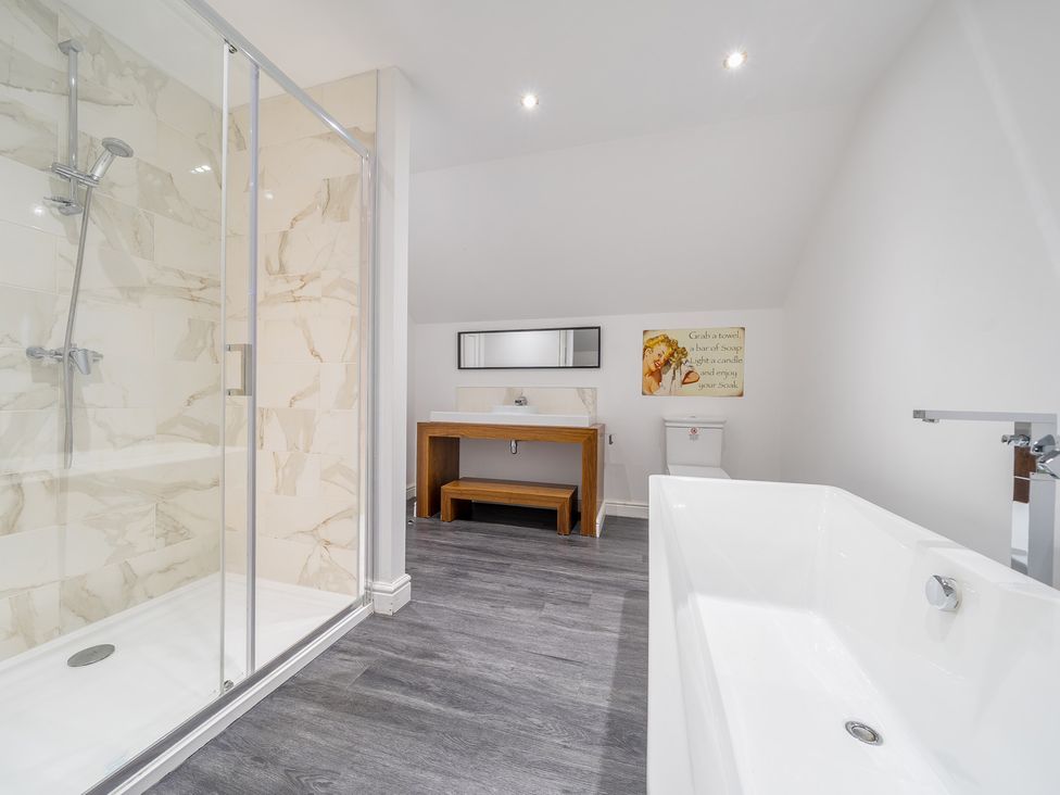 A bathroom with a shower, bathtub, sink, and toilet at Moor End Manor in Stalmine