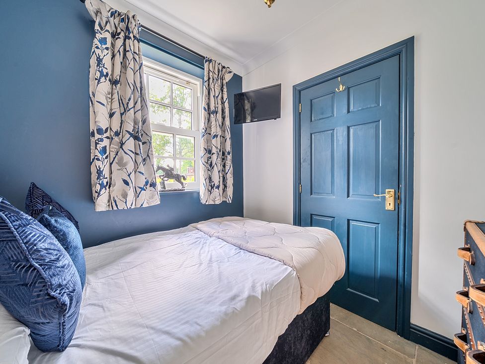 A bedroom with a bed and window at Moor End Manor Stalmine