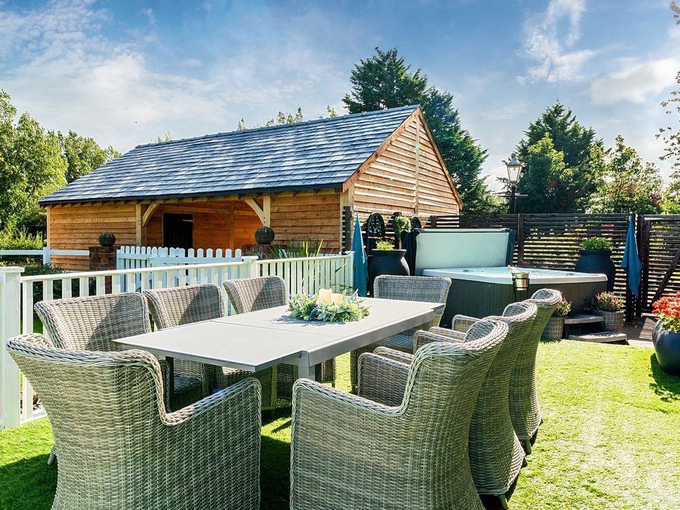 A garden with a table and chairs and a shed at Moor End Manor Stalmine
