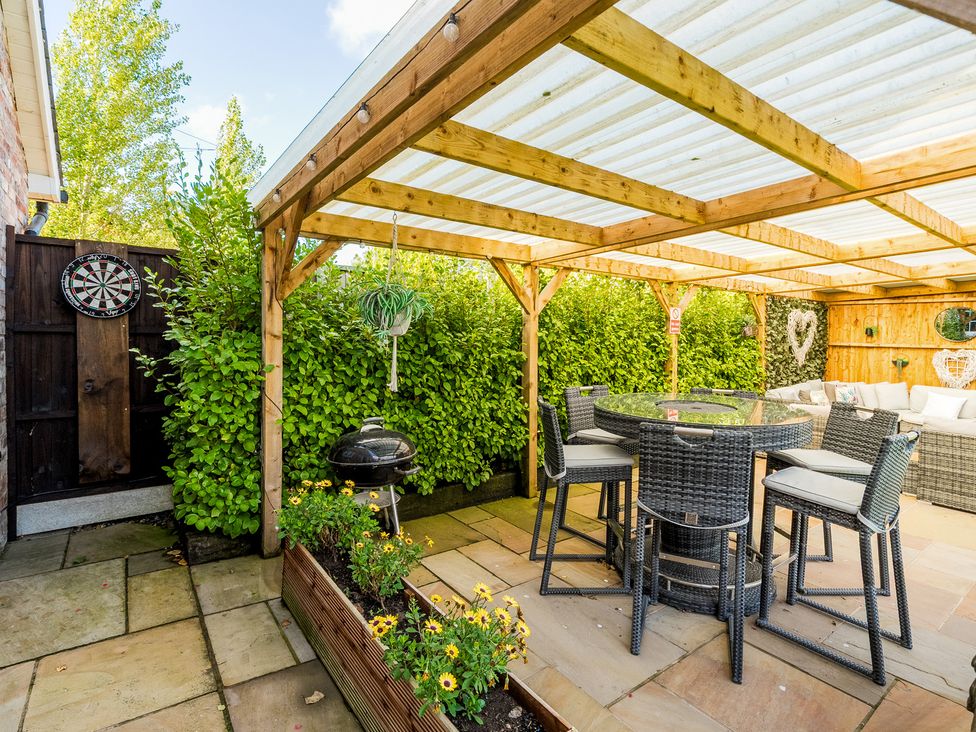 A garden with a table and chairs under a canopy at Moor End Manor Stalmine