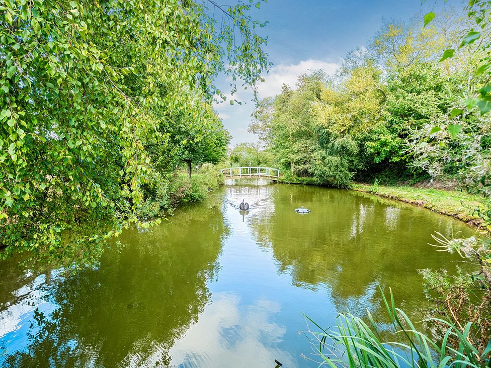 A pond with a bridge and ducks at Moor End Manor, Stalmine
