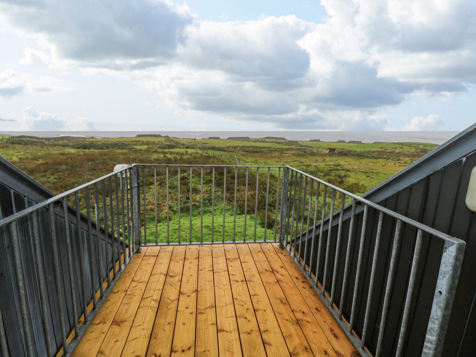 A balcony with a railing overlooking grassland and the sky at Ocean Sail House Termon near Dungloe County Donegal