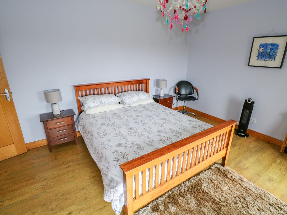 A bedroom with a bed and nightstand at Ocean Sail House, Termon near Dungloe, County Donegal